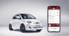 Fiat 500e silver car and phone showing FIAT app Powered by Enerfy with Japanese text on it