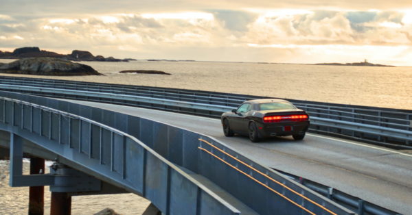 Car driving on a bridge in sunset