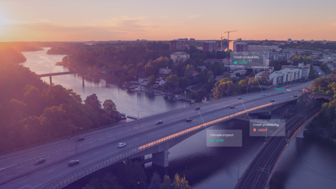 Aerial view of a highway bridge at sunset with AI overlays showing crash probability and climate impact for different cars on the road.