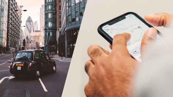 Car on the street and hand holding a phone and looking at a taxi app