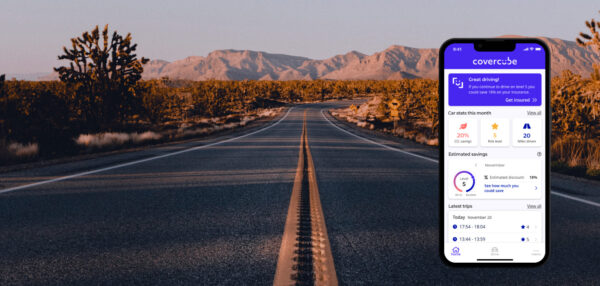 Showing a road with mountains and a phone displaying the Covercube app.