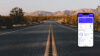 A road with mountains and a phone displaying the Covercube app