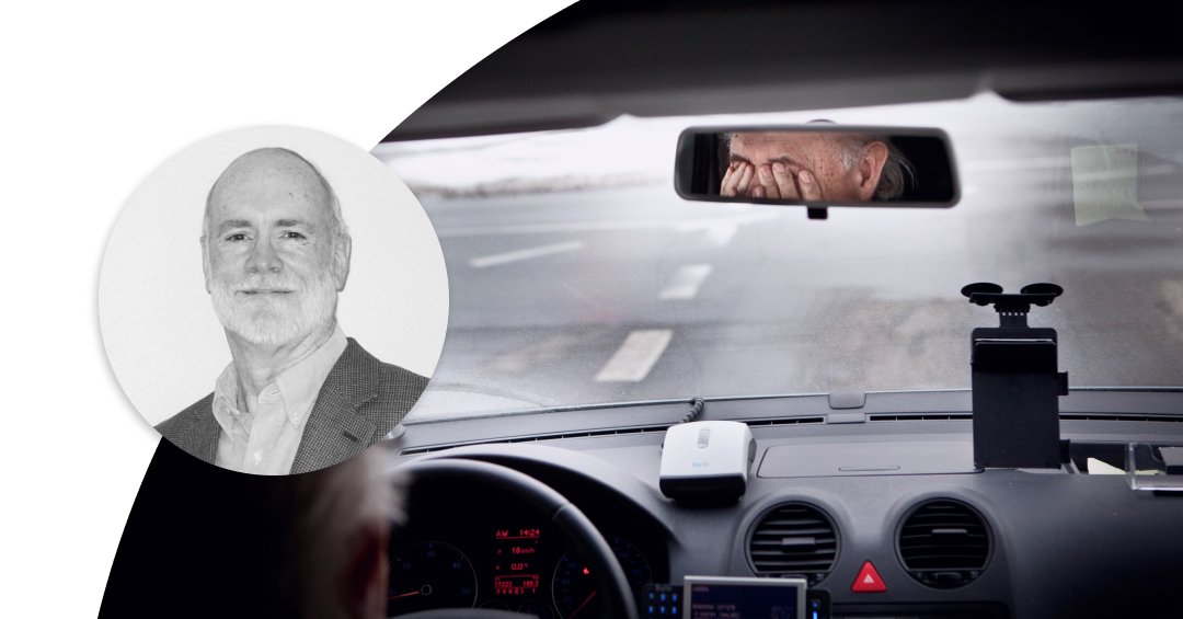 Profile image of Jim Noble and man driving a car while covering his eyes with the hands.