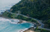 Australian landscape with a road by the ocean with cars driving with connected icons above them