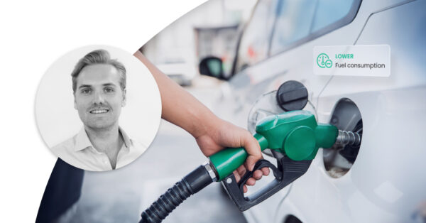 Hand filling up the car with fuel. Marker saying 