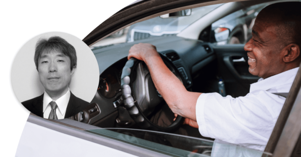 Man is smiling and while driving