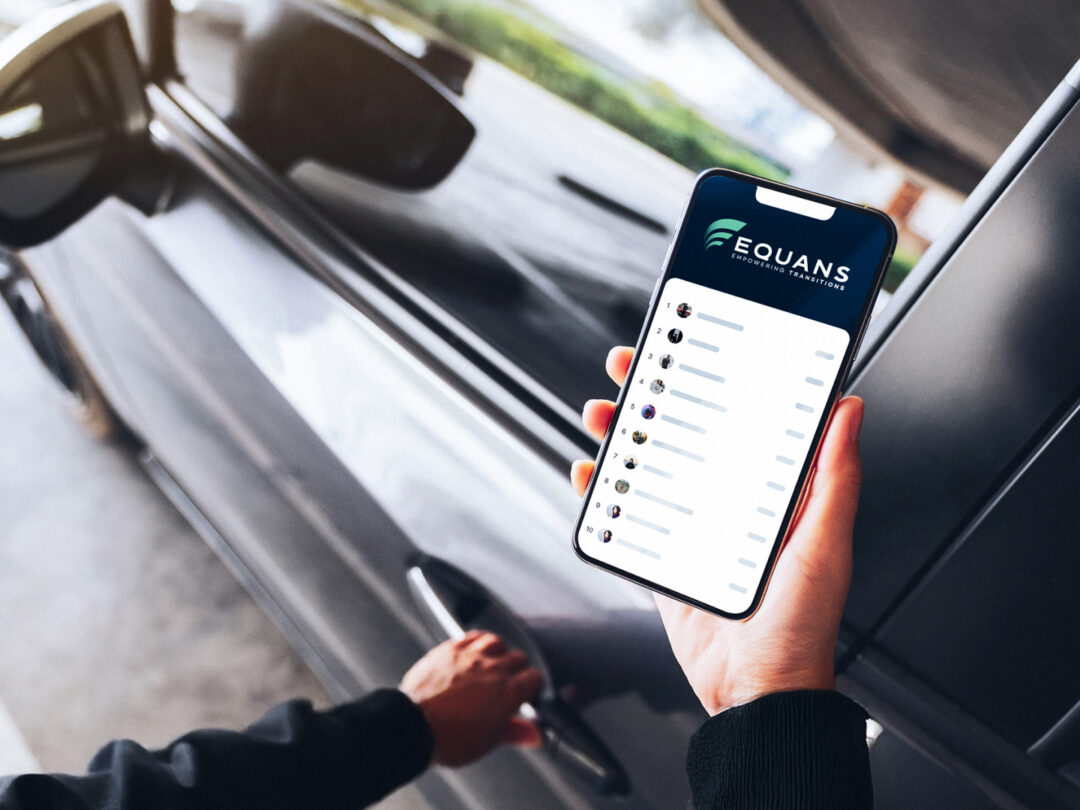 Person unlocking car while holding smartphone showing Equans Eco Driving Challenge.