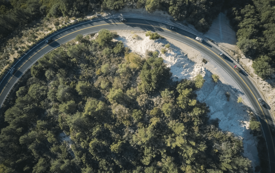 Cars driving in a curve in the nature.
