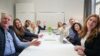 Greater Than team image in a conference room