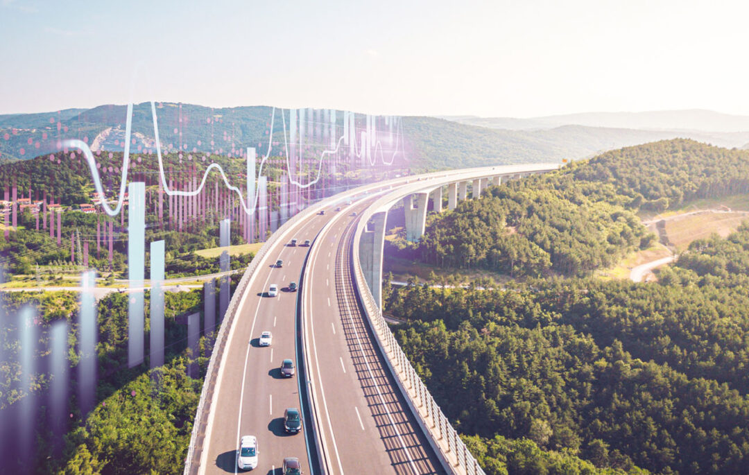 cars driving on a highway surrounded by nature