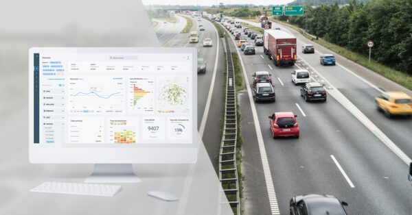 Greater Than's Risk portfolio tracker showing on screen and a freeway with cars