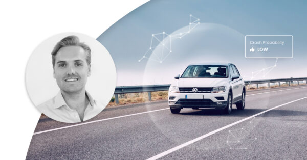 Car driving on a road with tech illustrations around it and marker saying 