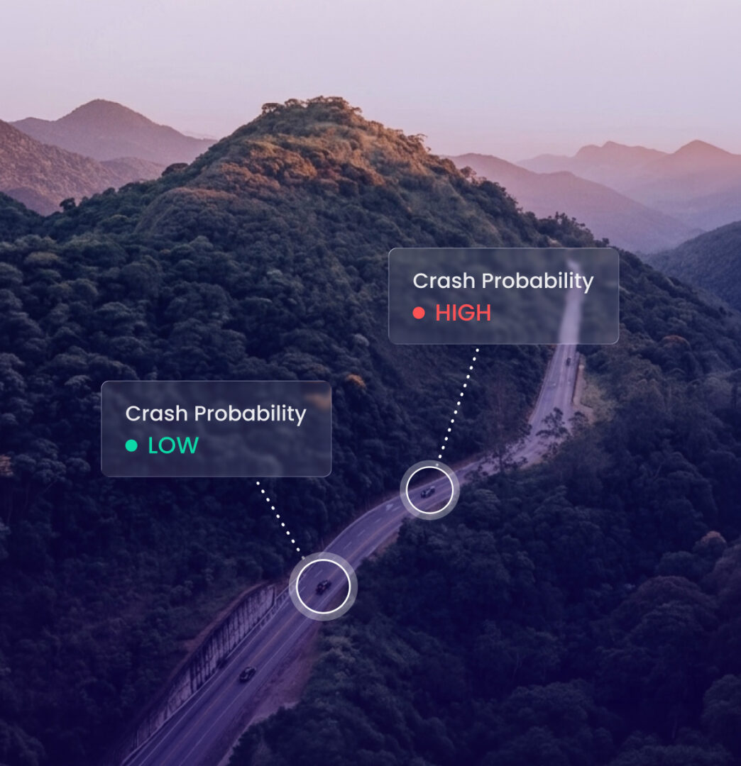 Aerial view of a winding road through a lush green mountain forest with overlay data bubbles indicating 