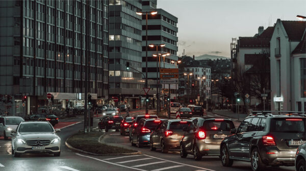 Cars driving in a city in the evening