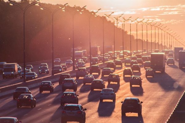 Cars driving on a freeway in sunset