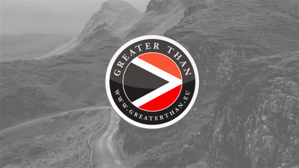 Greater Than's logo with a mountain in the background