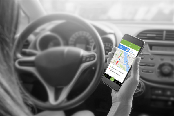 Woman driving a car and looking at her phone