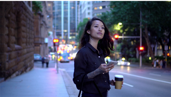 Woman holding her phone, phone is showing KINTO app
