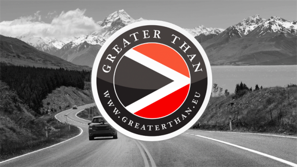 Car driving in the mountains and Greater Than's logo