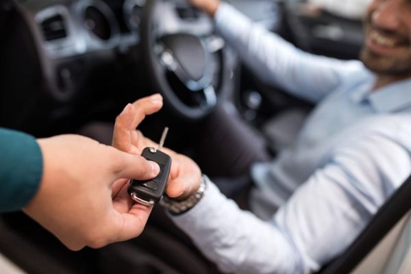 Man sitting in a car and getting car keys