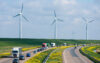Traffic on motorway with wind turbines in the background