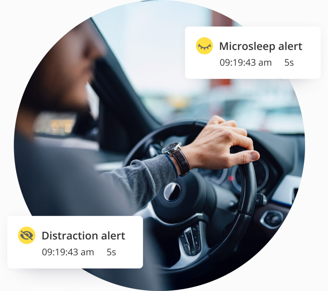 A picture from behind of a man driving a car. Overlaid with icons showing