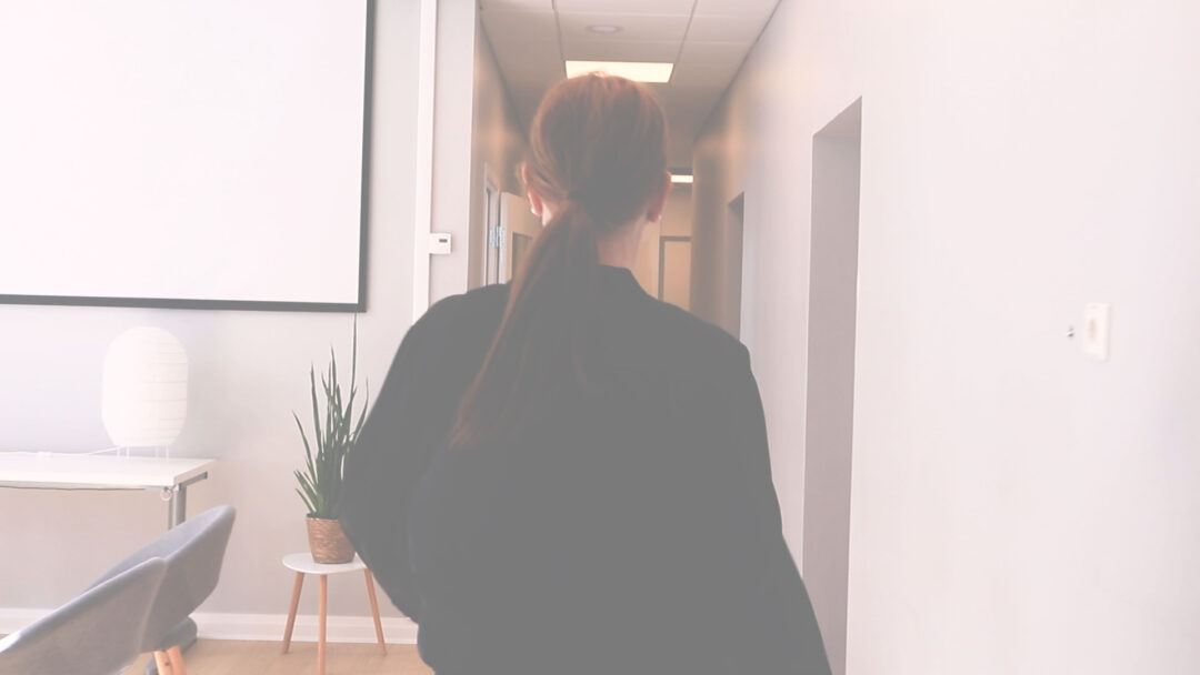 Liselott Johansson walking down a corridor in an office