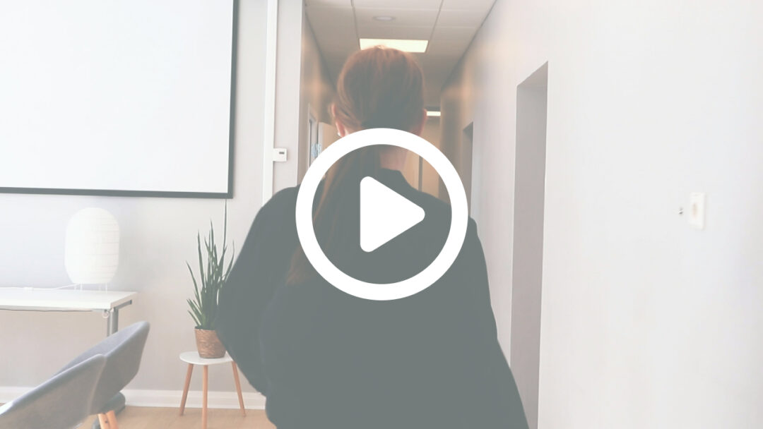 Liselott Johansson walking down a corridor in an office